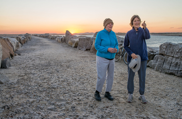 Bev and Marg on the breakwater at sunset