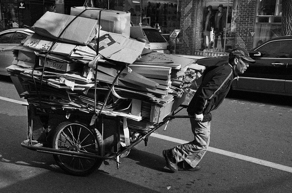 Man with hand cart of scrap