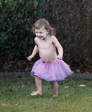 Mia running through the Sprinkler