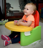 Mia playing with water in her new booster chair